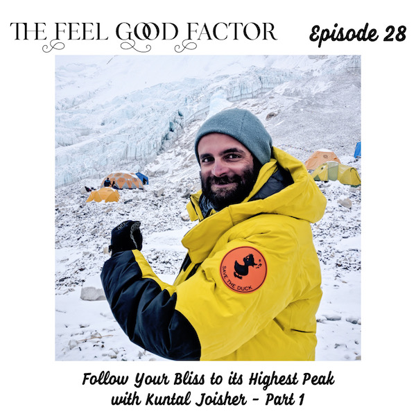 The Feel Good Factor. Episode 28. Indian vegan mountaineer with facial hair. Wearing warm gear. Turning to his right, head turned towards camera. Left arm extended in from of him to show save the duck icon on his shoulder sleeve. Snow in the background. Follow Your Bliss to its Highest Peak with Kuntal Joisher - Part 1