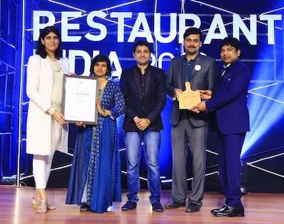 Susmitha, Ram and Mani receiving the Best Vegan/Healthy Restaurant award at Restaurant India Awards from Ritu Marya of Entrepreneur India