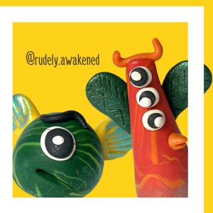 Text: @rudely.awakened Miniature clay creatures. One small green one with a single eye and yellowfins wings. Another red and orange one with three eyes, green wings and horns. Both peeking out of a thick white square border box.