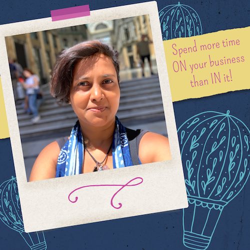 Polaroid style taped photo: head shot of Indian woman with short hair, sun shining on her face, smiling slightly and confidently at the camera, blurred background (some stairs). Text on right of photo, “Spend more time ON your business than IN it.” Doodles of hot air balloons in the background.