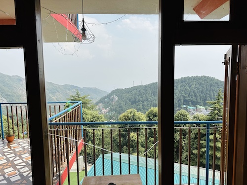 View of the mountains and sky outside the window of room Jal 9 at The Unmad, Dharamkot (Dharamshala)