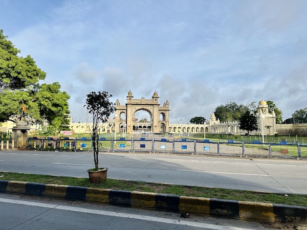 Morning view of the Mysore Palace from across the main road. No people around. Beautiful, peaceful view of the palace facade and blue sky.