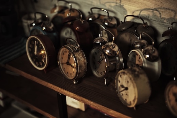 Antique alarm clocks on a wooden table.