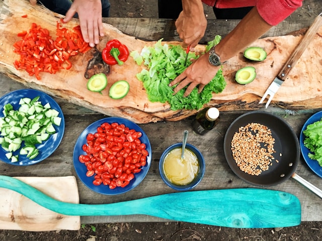 Overhead view of veggies and other ingredients being prepped on a table. How to plan and teach a vegan cooking class.