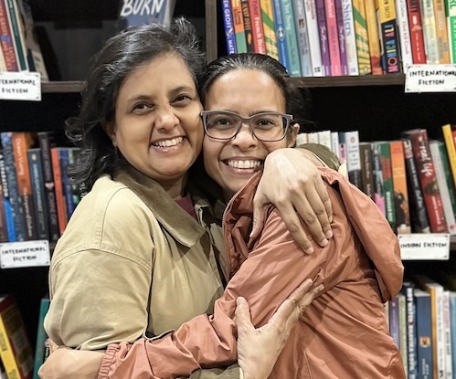 Susmitha and Ekta hugging eachother at Beku Cafe Bookstore.